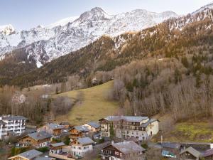 a group of houses in front of a mountain at ibis Styles Les Houches Chamonix in Les Houches