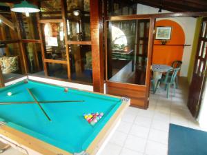 a pool table in the middle of a room at Vale Verde Praia Hotel in Porto Seguro