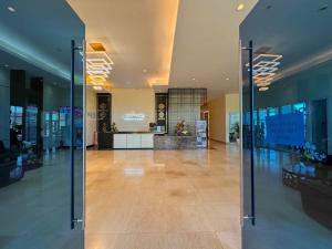an empty lobby with glass doors in a building at Sophisticated Oceanview Studio in La Mirada in Mactan