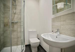 a bathroom with a sink and a toilet and a shower at The Bayard Plaza in Peterborough