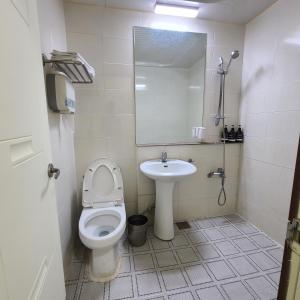 a small bathroom with a toilet and a sink at Danggum Stay in Suncheon