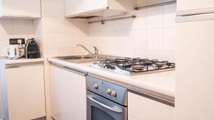 a kitchen with a stove and a sink at APPARTAMENTO Superhouse PIAZZA DUOMO AREA in Milan