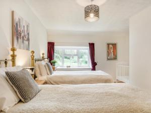 a bedroom with two beds and a window at 2 Bed in Bridport 58848 in Powerstock