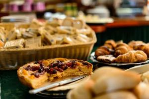 a table with a slice of pizza and other pastries at PFA Hotel Viareggio in Viareggio