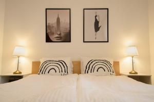 een slaapkamer met 2 witte bedden en 2 lampen bij Peony Káldy Apartman Free Garage under the house in Boedapest