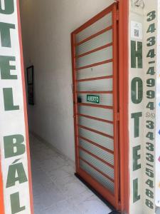 uma grande porta de garagem metálica com um sinal em BALSAMO HOTEL em Marília