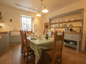 a dining room with a table and chairs in a kitchen at 3 Bed in Shap 74159 in Shap