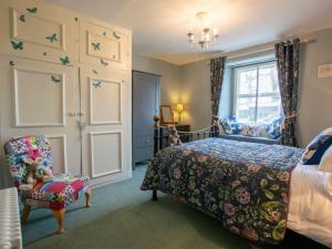 a bedroom with a bed and a chair and a window at 3 Bed in Shap 74159 in Shap