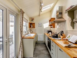 a small kitchen with a sink and a stove at 2 Bed in Grange Over Sands 73544 in Grange Over Sands