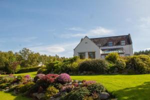 a house with a garden in front of it at Carriden in Insh