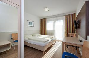 Rúm í herbergi á Hotel Kolping Wien Zentral