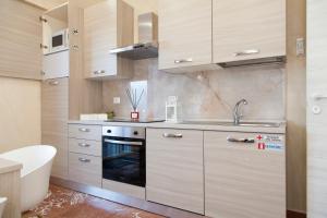 a kitchen with a sink and a stove at Luxury house Il tramonto in Anzio