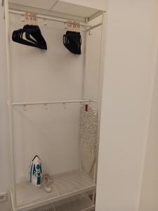 a closet with a white refrigerator with two shelves at Puerta de Hierro Apartments in Madrid