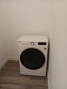 a white microwave oven sitting next to a white wall at Puerta de Hierro Apartments in Madrid