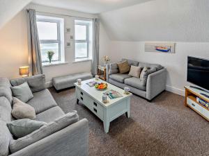 a living room with two couches and a tv at 2 Bed in Woolacombe 76350 in Woolacombe