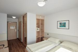 Rúm í herbergi á Hotel Kolping Wien Zentral