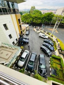 a group of cars parked in a parking lot at Qualibest Grand Hotels in Abuja