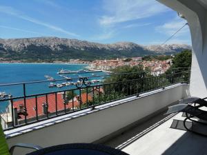 a balcony with a view of a body of water at Apartments Andrea in Baška