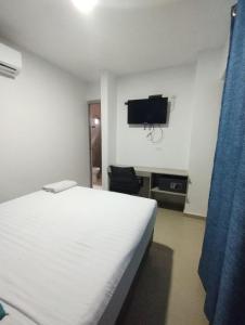 a bedroom with a bed and a flat screen tv at HOTEL BELLAMAR in Cartagena de Indias +64 photos