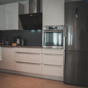 uma cozinha com um frigorífico e um micro-ondas em K&T Estate Resort & Spa - Flughafennahe Gästesuite em Hofheim am Taunus