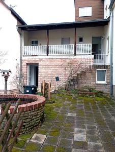 a brick house with a porch and a brick wall at Monteurwohnung Renate in Saarbrücken