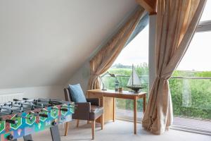 a room with a bed and a desk and a window at KingFisher Hot Tub & log Burner house on Premium lakeside with Resort Facilities in Saint Columb Major