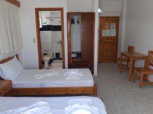 a hotel room with two beds and a bathroom at Your Second Home 2 in Kámpos +55 photos