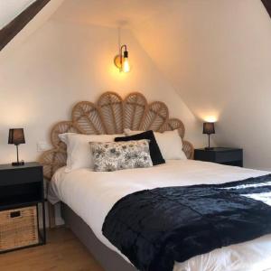a bedroom with a large bed with a wooden headboard at L'appart des Halles Tours centre in Tours