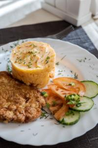 a plate of food with meat and vegetables on it at Вілла ЮРАН Східниця in Skhidnitsa