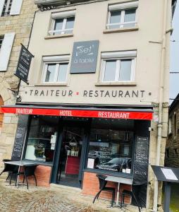 a restaurant with tables in front of a building at Set A Table in Broons