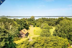 an aerial view of a house in the woods next to a lake at Ferienhaus Wilde Wiese in Sellin