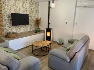 a living room with two couches and a tv at CAN´SELMA 1 in Chella