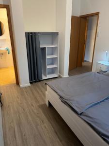 a bedroom with a bed and a closet in it at Haus Monika in Juist