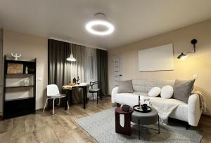 a living room with a couch and a table at New Charm Apartments near Border in Narva