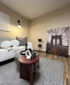 a bedroom with a bed and a bridge painting on the wall at New Charm Apartments near Border in Narva