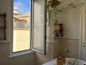 a bathroom with a window and a sink and a tub at Appartamento S. Pietro in Rome