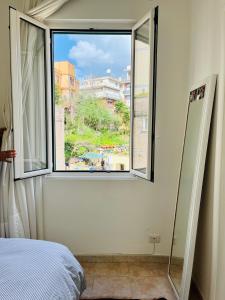 a bedroom with a window with a view of a city at Appartamento S. Pietro in Rome