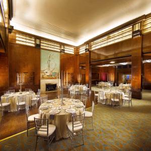 a banquet hall with white tables and chairs at The Queen Mary in Long Beach