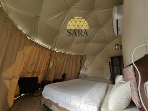 a bedroom with a bed in a tent at SARA LUXURY RUM CAMp in Wadi Rum