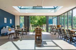 a restaurant with tables and chairs and large windows at 61 Durham in Durham