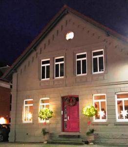 een huis met een rode deur 's nachts bij Ferienwohnung Schönwälder 