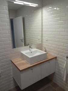 a bathroom with a white sink and a mirror at APARTMÁN in Turčianske Teplice