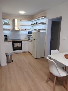 a kitchen with a table and a white refrigerator at APARTMÁN in Turčianske Teplice