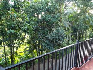 a black fence in front of a forest of trees at Enara Luxury Stay in Katugastota