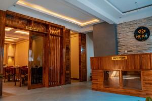 a restaurant lobby with a fireplace and a sign on the wall at Nexa Hotel in Arusha