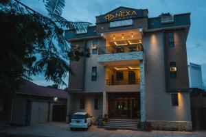 a building with a car parked in front of it at Nexa Hotel in Arusha