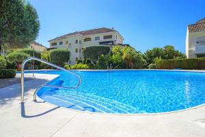 a swimming pool in front of a house at modern apartment by the sea.(Marbella) in Marbella
