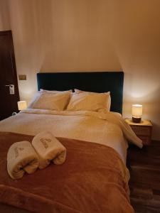 a bedroom with a large bed with two towels on it at Casa do Romezal in Peso da Régua