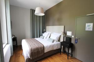 Un pat sau paturi într-o cameră la Manoir de Montigny