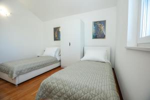 Postel nebo postele na pokoji v ubytování Apartments Seafront